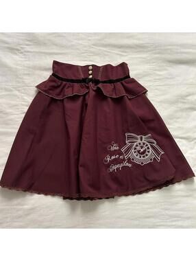 Axes Femme Burgundy skirt with lace trim and bow embroidery detail